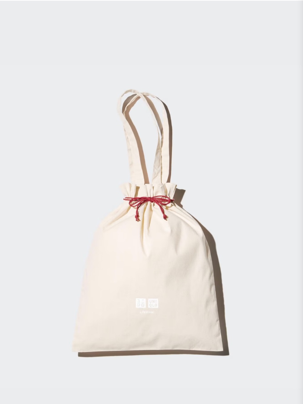 UNIQLO Cream Drawstring Tote with Red Tie